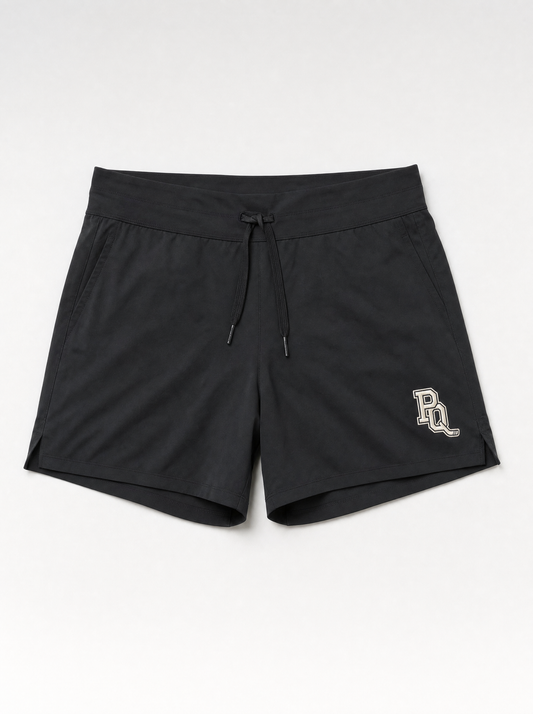 Black Puck Queens dryland training shorts with the cream PQ monogram embroidered at the left hip